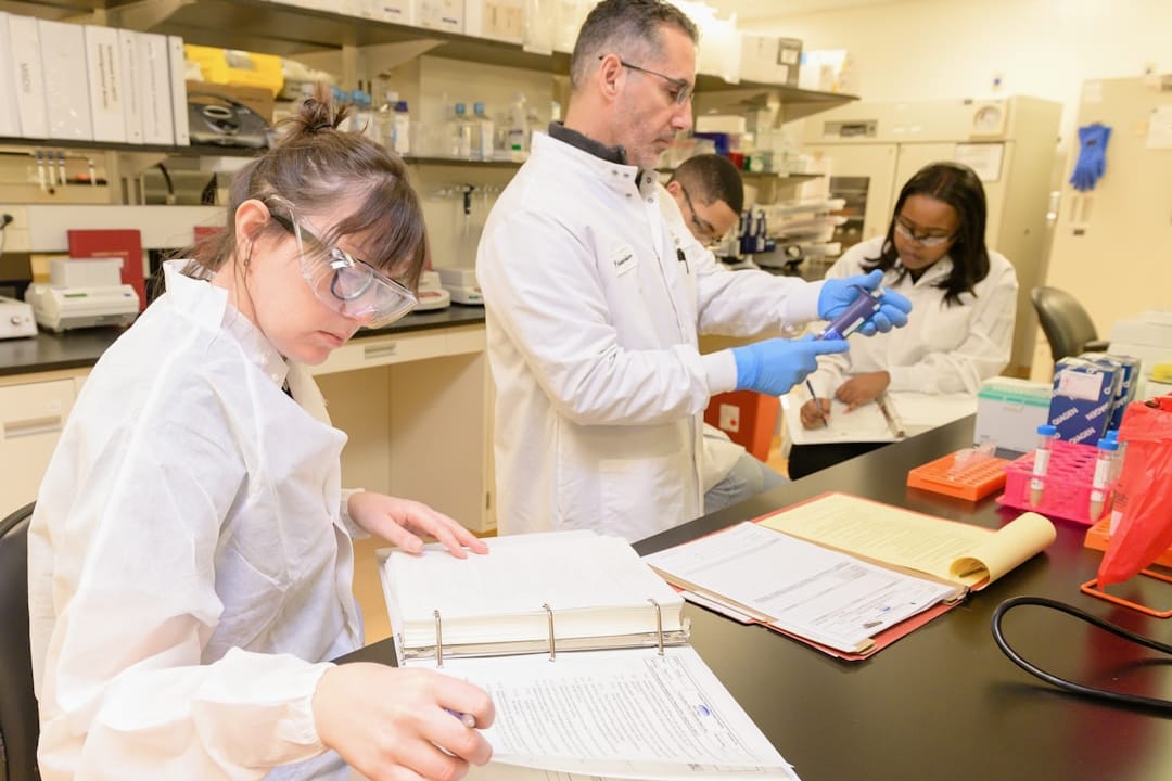 Scientists examining CDC vaccine effectiveness study data on monitors Scientists examining CDC vaccine effectiveness study data on monitors